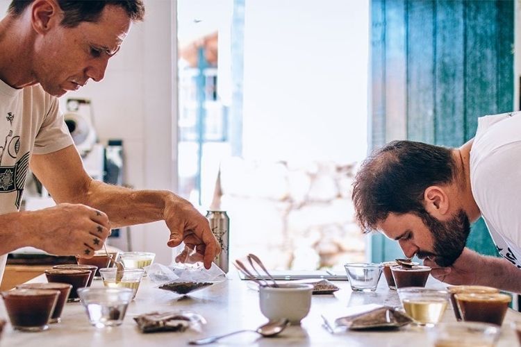 Homens provando café no método cupping